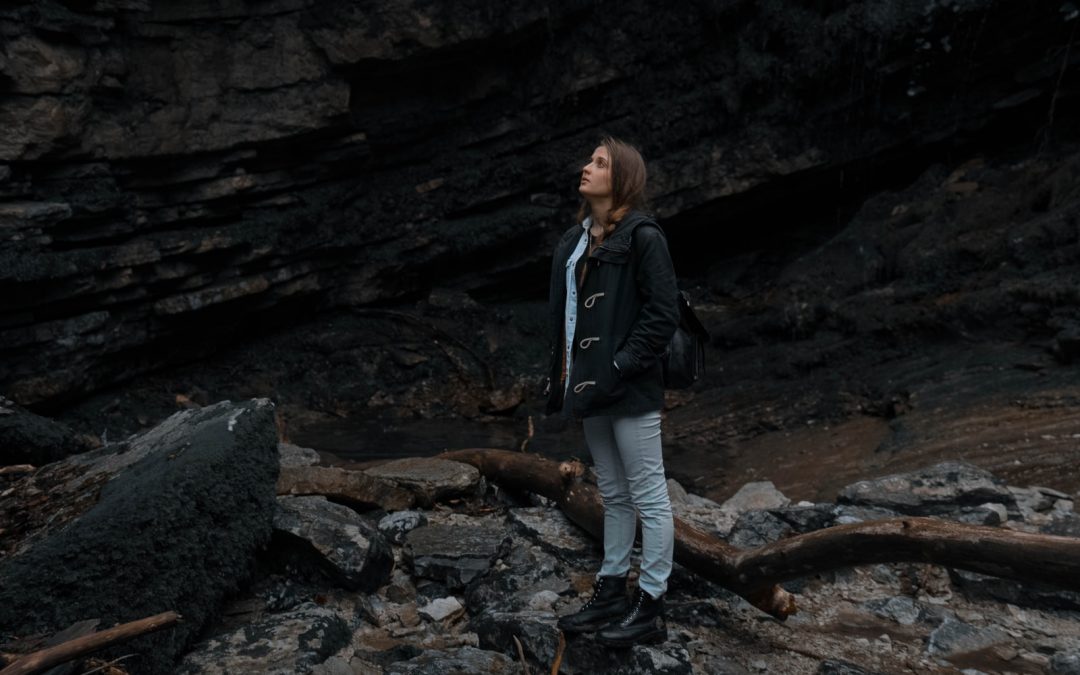 woman standing near rock formation