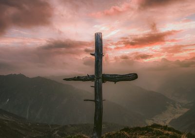 grey wooden cross on mountain