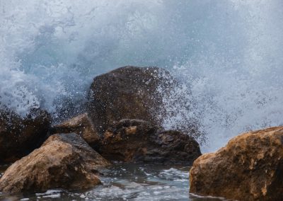water waves hitting rocks during daytime