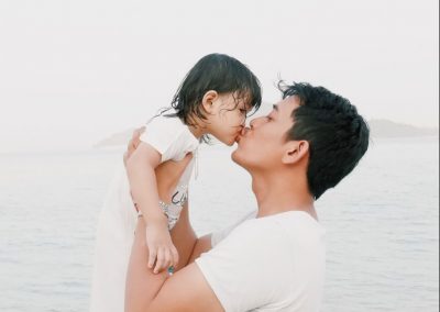 Fatherly love for kingdom man kissing toddler during daytime