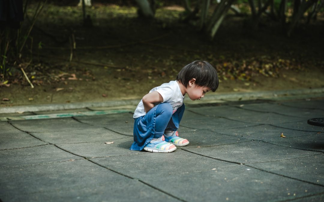 baby in white t-shirt and blue jeans on ground
