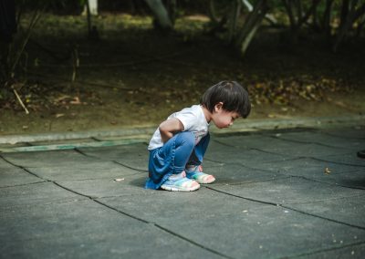 baby in white t-shirt and blue jeans on ground