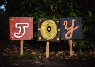 three assorted-color joy signage