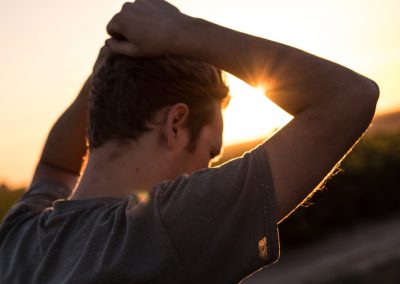 man holding his hair against sunlight