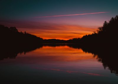 red sky reflecting body of water