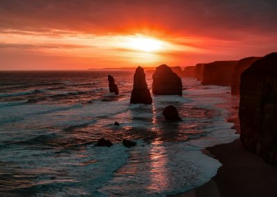 silhouette of stone on seashore during golden hour