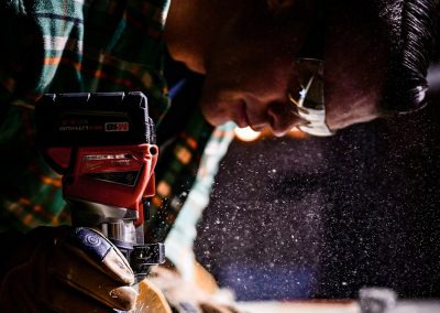 person holding orange and black power tool
