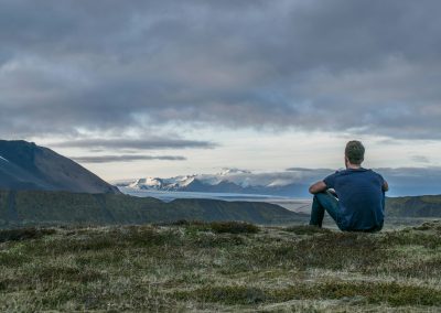 man sitting in the top of the mountain