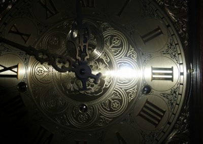 brass-colored analog clock