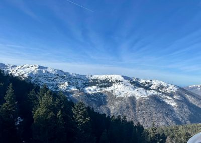 a view of a snowy mountain range from a ski slope