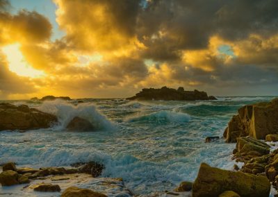 a rocky beach with waves crashing
