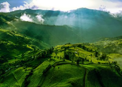 green grass field under white clouds during daytime