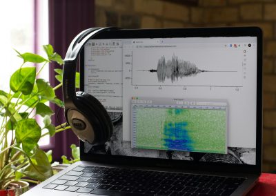 a laptop computer with headphones on top of it